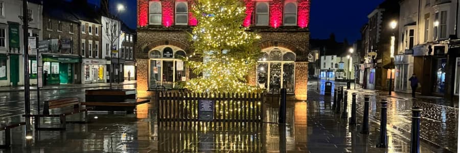 Christmas tree reflections on wet streets