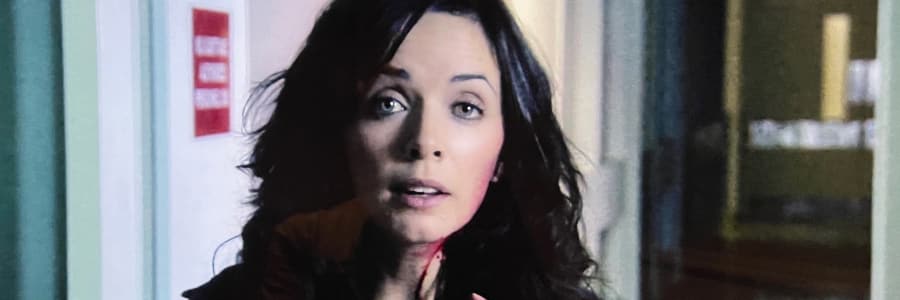 A woman looking angrily at the camera because her boyfriend is filming her during a zombie apocalypse.