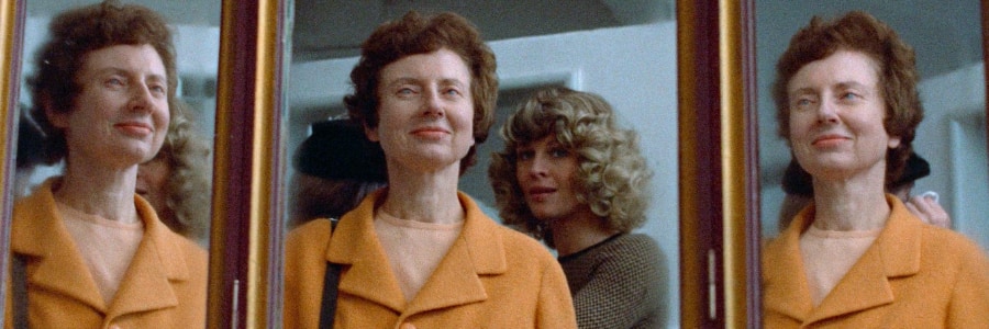 Laura with the smiling blind psychic reflected three times in mirrors.