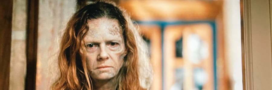 A zombie wife is chained in the kitchen and looks angrily at us.