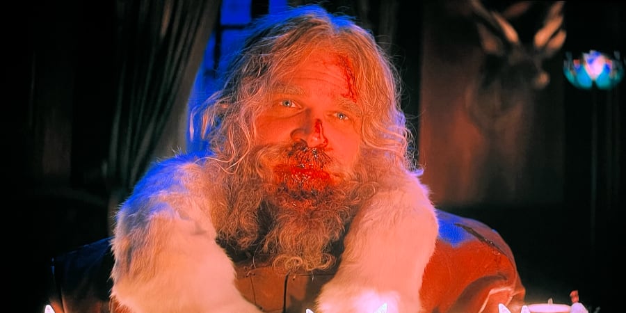 Santa Claus with a bloody nose looking at someone with unexpected violence.