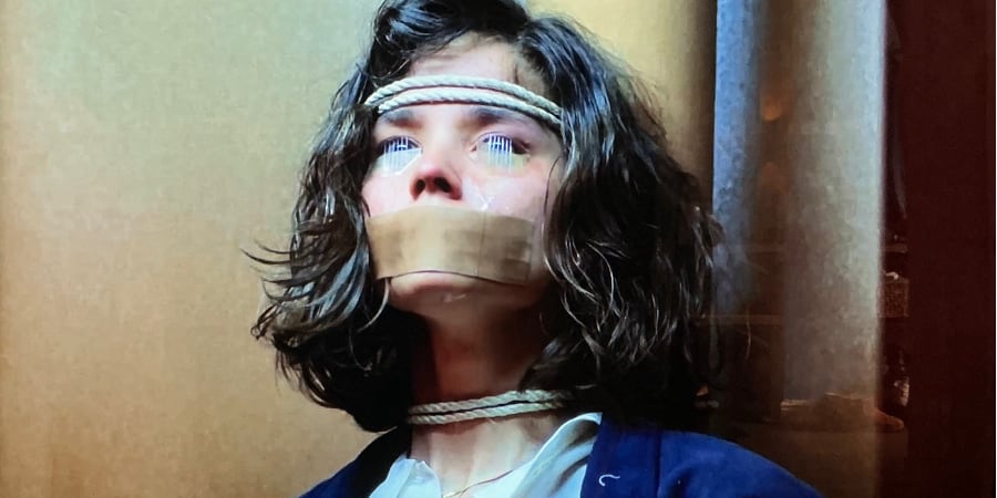 A woman with needles pinned over her eyes.