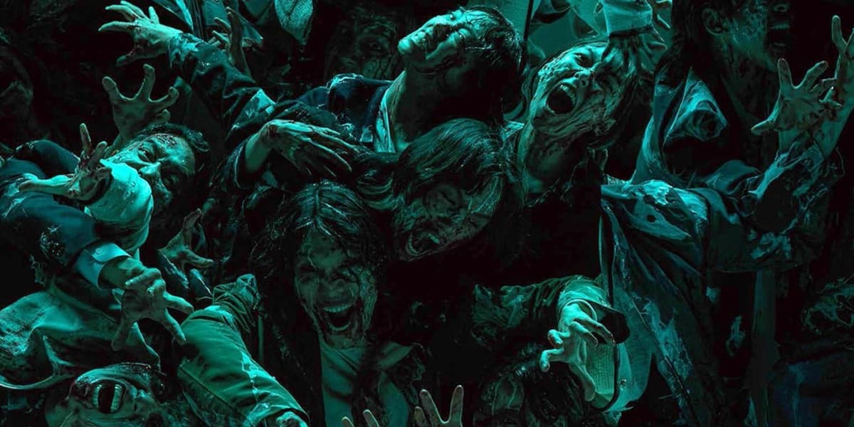 A mass of zombies reach for the camera.
