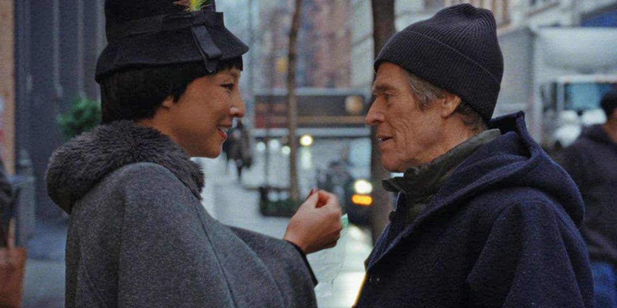 A man and a woman looking at each other and smiling on a New york street